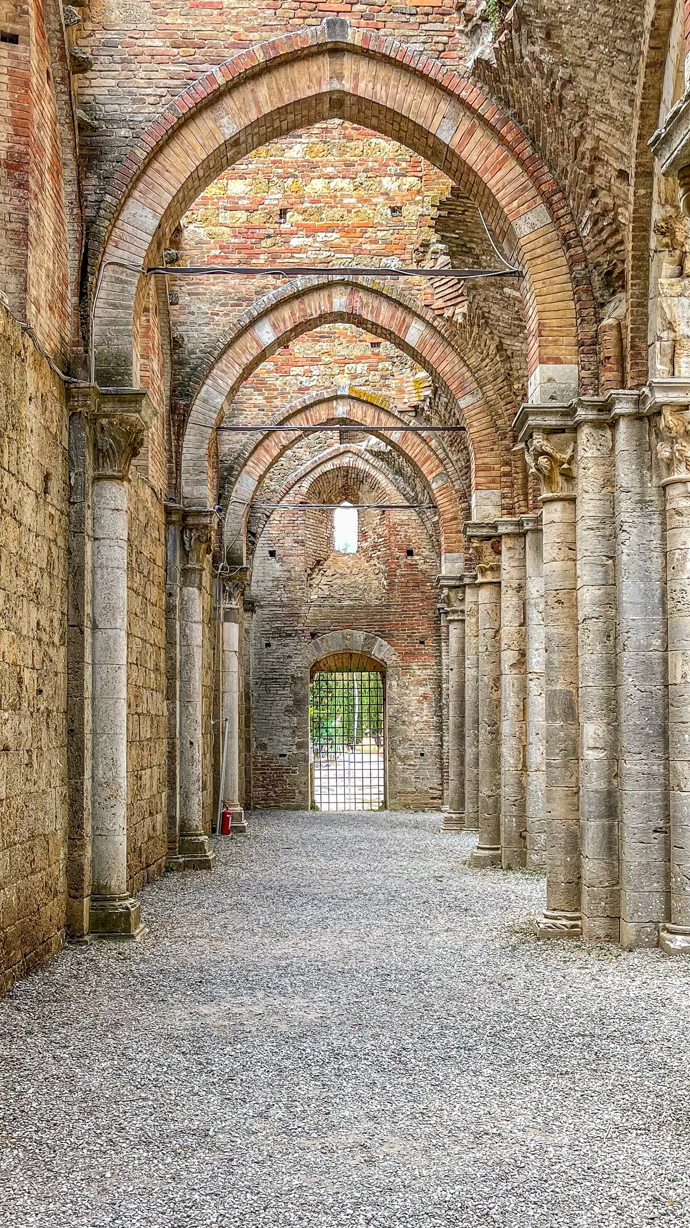 Ancient stone abbey with arches in Tuscany
